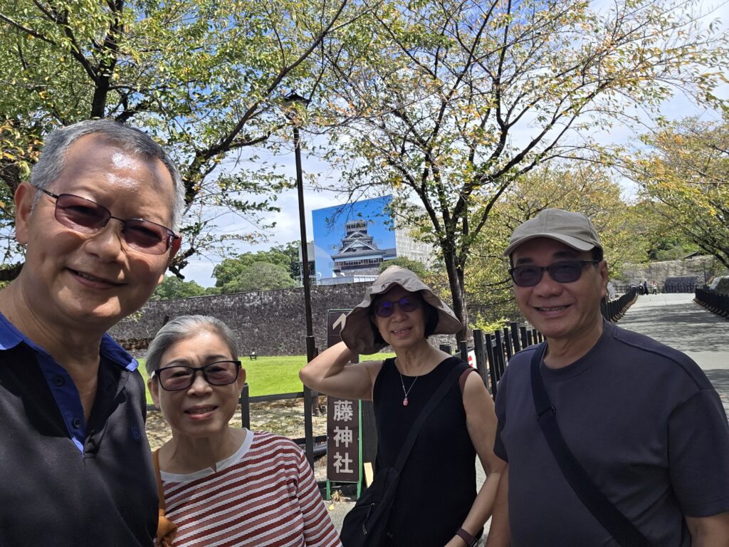 Visit Kumamoto Castle (under repairs in the background)