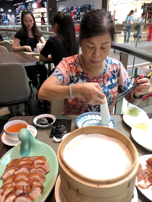 Preparing the skin for wrapping the Peking Duck meat