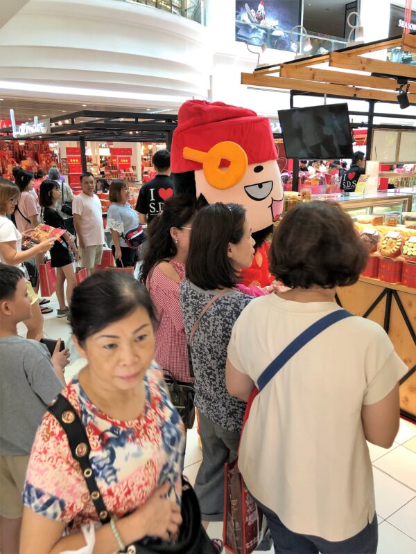 Wealth and Happiness walking around greeting the customers
